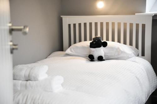 a stuffed animal sitting on top of a bed at 5 Glenconon Bed and Breakfast in Uig