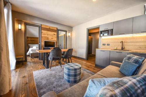 a living room with a couch and a table at Chalet Everest - Luxury Apartments in Prato Nevoso
