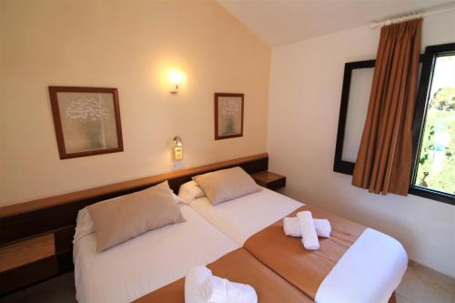 Postel nebo postele na pokoji v ubytování Apartaments Talayot