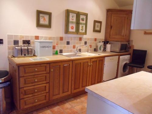 a kitchen with a sink and a counter top at 2 Bed Barn near Newport Shropshire in Newport
