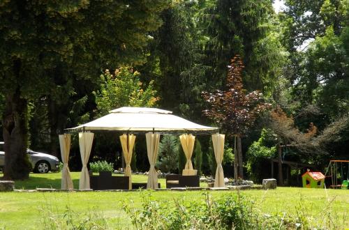 a gazebo in a park in a field at Maison Du Ruisseau in Malaville