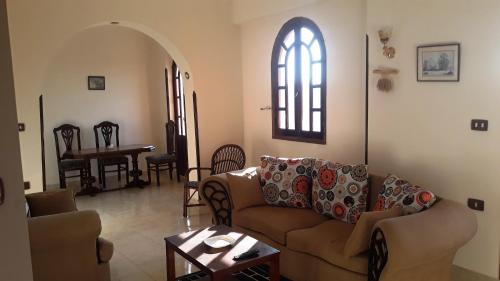 a living room with a couch and a table at Moonlight Home in Luxor