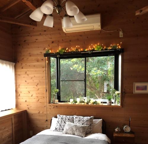 a bedroom with a window with christmas lights on it at 屋久島シエスタYakushima Entire house with a wonderful view in Yakushima