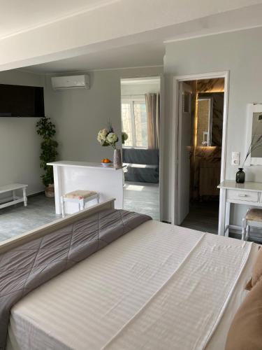 a bedroom with a large white bed in a room at Rokamare Beach Resort in Liapades