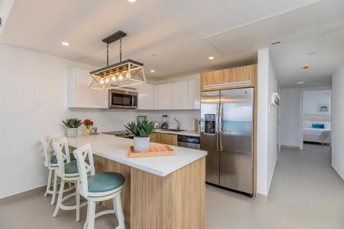 a kitchen with a counter and a refrigerator at Azure Beach Residences in Palm-Eagle Beach