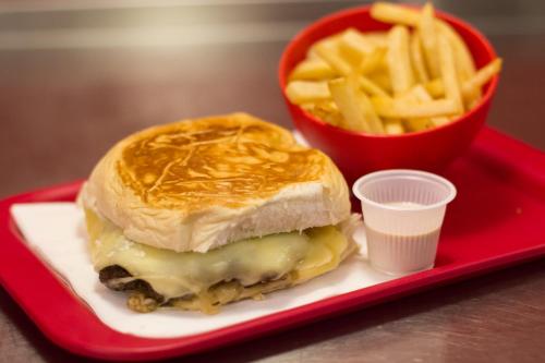 a sandwich and french fries on a red tray at ibis Maceio Pajuçara in Maceió