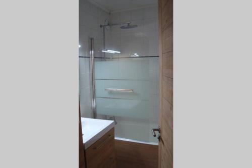 a bathroom with a shower and a white sink at Val Thorens 2 bedrooms 6 persons next slopes in Val Thorens