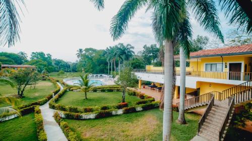 a view of a resort with palm trees at La Iguana de Santa Fe by Bernalo Hotels in Santa Fe de Antioquia