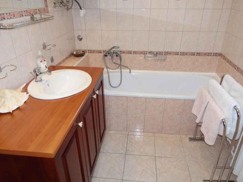 a bathroom with a sink and a bath tub at Holiday home in Gyenesdias - Balaton 40755 in Gyenesdiás