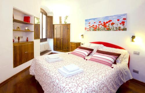 a bedroom with a bed with two plates on it at Old Convent in Via De Neri in Florence