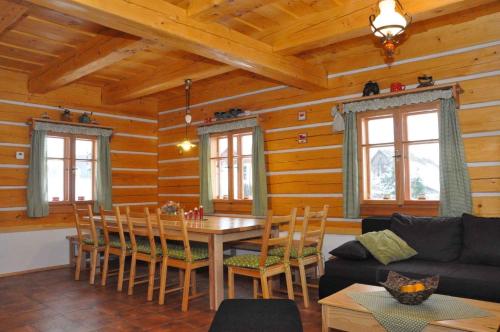 a living room with a table and chairs in a cabin at Holiday home in Zahori u Semil - Isergebirge 38483 in Dlouhý