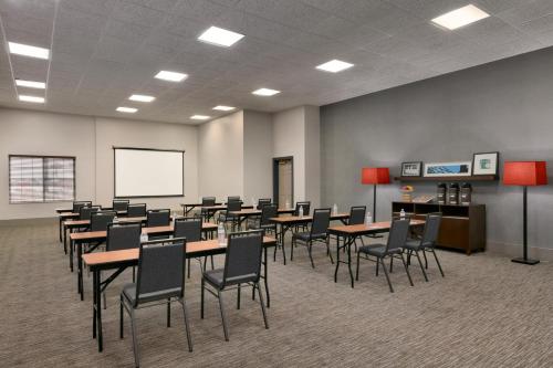 a conference room with tables and chairs and a whiteboard at Country Inn & Suites by Radisson, London, KY in London