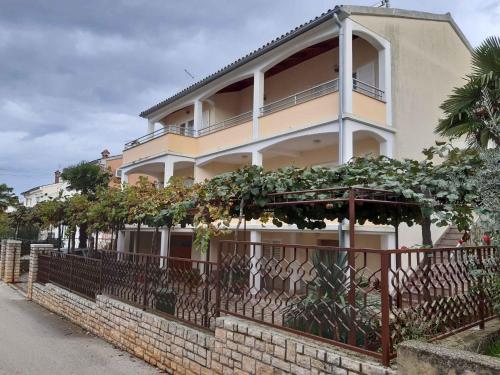 a large house with a fence in front of it at Apartments in Porec/Istrien 40404 in Poreč