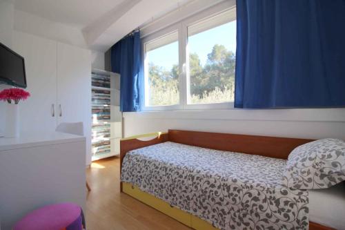 a bedroom with a bed and a window at Apartment in Porec/Istrien 40339 in Poreč