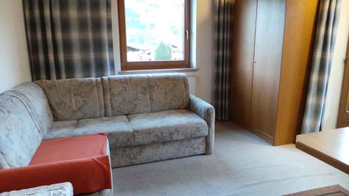 a living room with a couch and a window at Apartments in Kaltenbach/Zillertal 751 in Kaltenbach