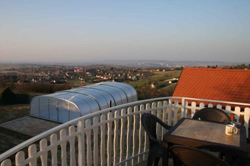 a balcony with a table and chairs and a building at Holiday home Cserszegtomaj - Balaton 39729 in Cserszegtomaj