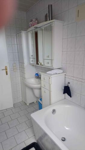 a white bathroom with a sink and a toilet at Apartment in Eibenstock 30354 in Eibenstock