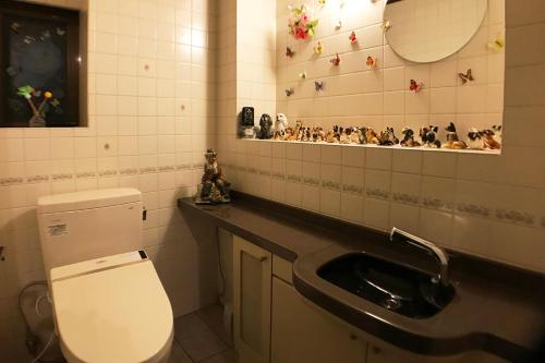 a bathroom with a toilet and a sink at Nakagawa's Cozy House in Sakai