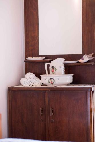 a wooden cabinet with a mirror and towels on it at Apartment in Stivan - Insel Cres 37906 in Štivan