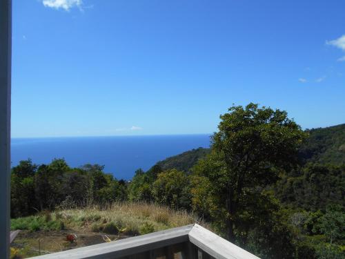 a view of the ocean from the balcony of a house at Diamond View Cottages in Roseau