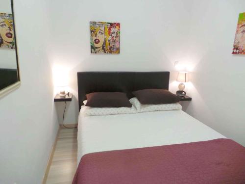 a bedroom with a large bed with two lamps at Apartment in Umag/Istrien 37005 in Umag