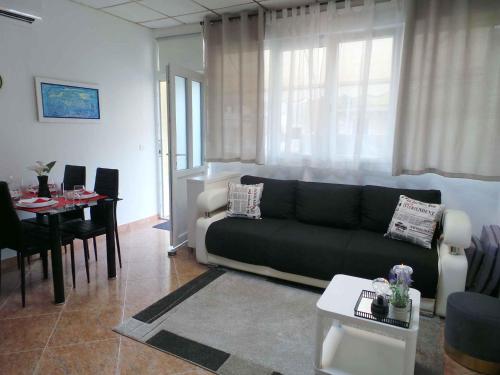 a living room with a black couch and a table at Apartment in Umag/Istrien 37005 in Umag