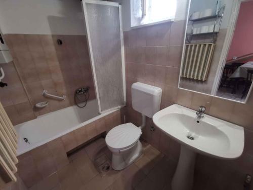 a bathroom with a white toilet and a sink at Holiday home in Balatonmariafürdo 26243 in Balatonmáriafürdő