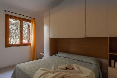 a bedroom with a bed with a tray on it at Holiday home in San Teodoro 26875 in San Teodoro