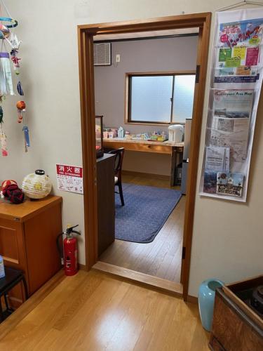 a room with a door open to a room with a desk at Houtouji Temple in Yoshino