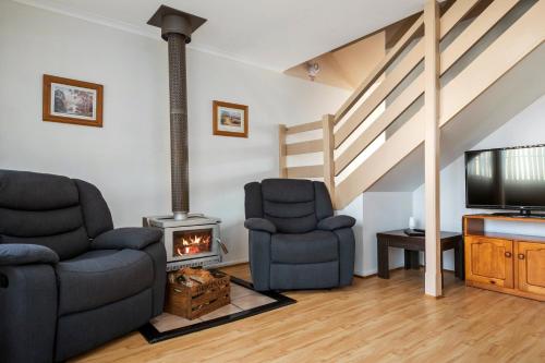 
a living room filled with furniture and a fire place at SWANSEA VILLAS in Swansea
