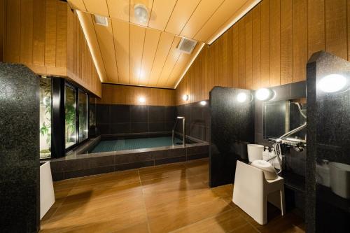 a bathroom with a bath tub and a shower at Hotel Shuranza Chiba in Chiba