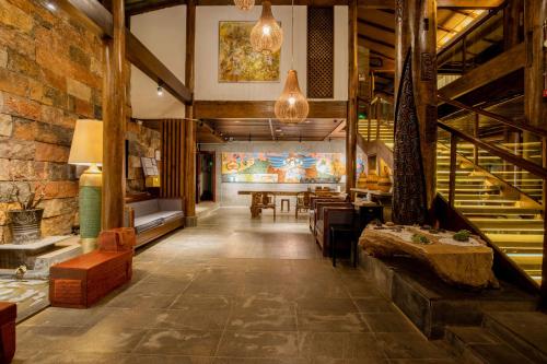 a large room with a table and chairs in a building at 丽江束河元年别院 Yuannian Lijiang in Lijiang