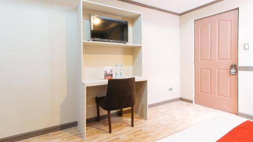 a room with a desk with a chair and a door at RedDoorz Plus at Canley Residential in Manila