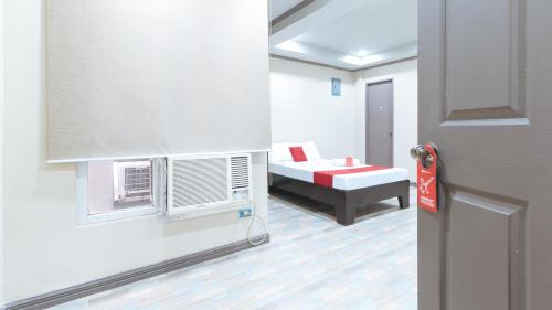 a small room with a bed and a window at RedDoorz Plus at Canley Residential in Manila