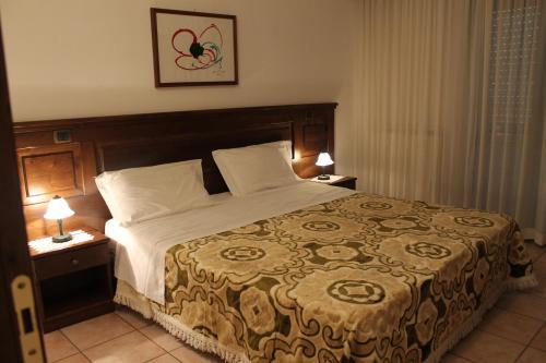 Кровать или кровати в номере Residence La Piscina