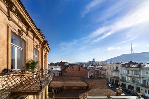 a view of the city from the balcony of a building at Unfound Door - Design Hotel in Tbilisi City