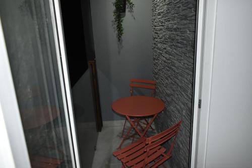 a table and two chairs sitting next to a window at WooW Apartments in Velika Gorica