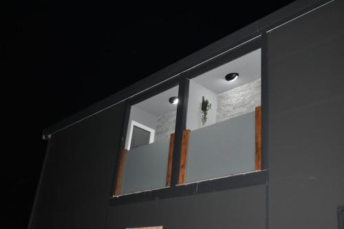 a window on a wall with a light on it at WooW Apartments in Velika Gorica