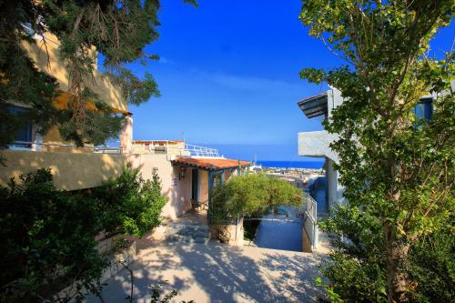 a view of a building with the ocean in the background at Stelva Villas in Hersonissos