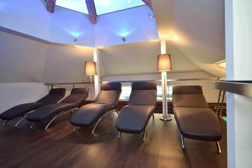 a row of chairs in a waiting room with lights at Hotel Garni Fimba in Ischgl