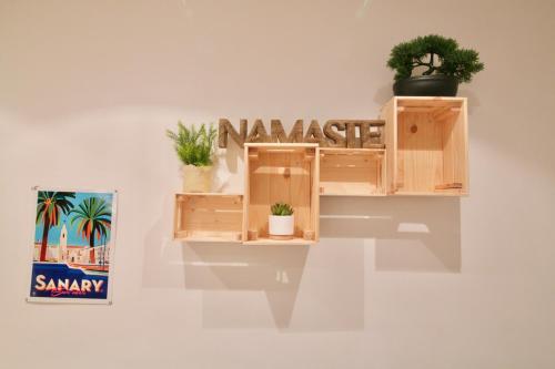 a wooden shelf with potted plants on a wall at Au coeur de Sanary-sur-Mer studio cosy in Sanary-sur-Mer