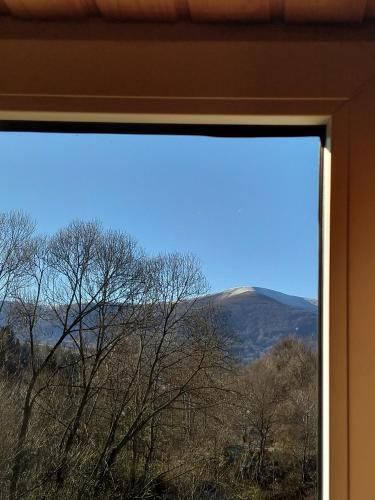a window with a view of trees and mountains at "Відпочинок в Карпатах" in Izki