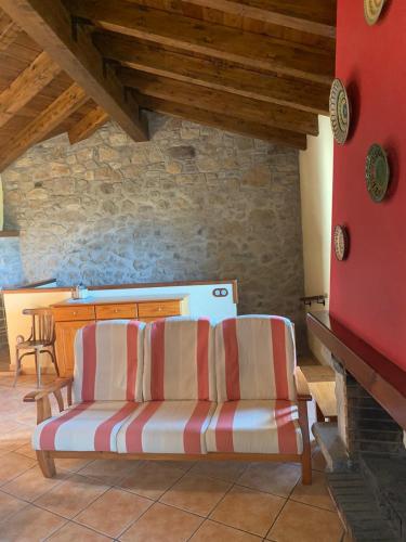 a living room with a couch and a table at Ca L'Isidret in Lles