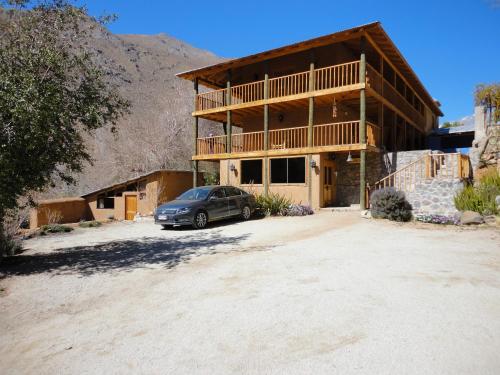 a house with a car parked in front of it at Hotel Casona Distante in Alcoguaz