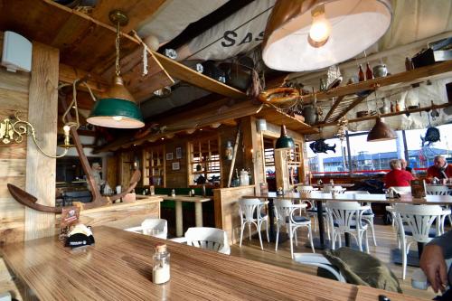a restaurant with tables and chairs and people in it at Meerforelle 207 - Villa Seeblick in Sassnitz