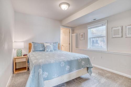 a bedroom with a bed and a window at HipNautic in Depoe Bay