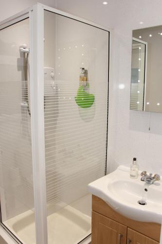 a bathroom with a shower and a sink at Invergarry Room Only Guest House For Adults in Windermere