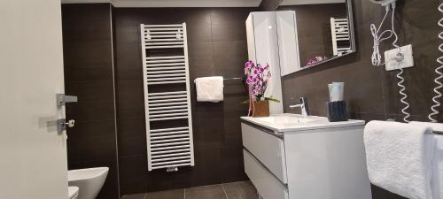 a bathroom with a sink and a mirror at RivAppartamenti in Riva del Garda