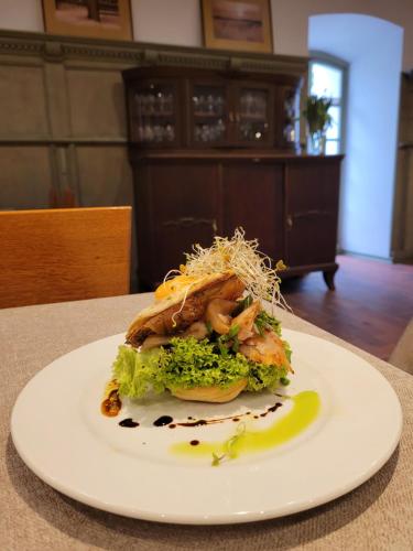 a plate of food sitting on a table at Spichlerz na Krakowskiej in Kazimierz Dolny