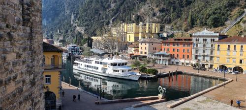 a boat is docked in a river in a city at RivAppartamenti in Riva del Garda